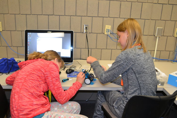 Two girls learning how things work