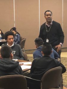 A man gives students a presentation about his work