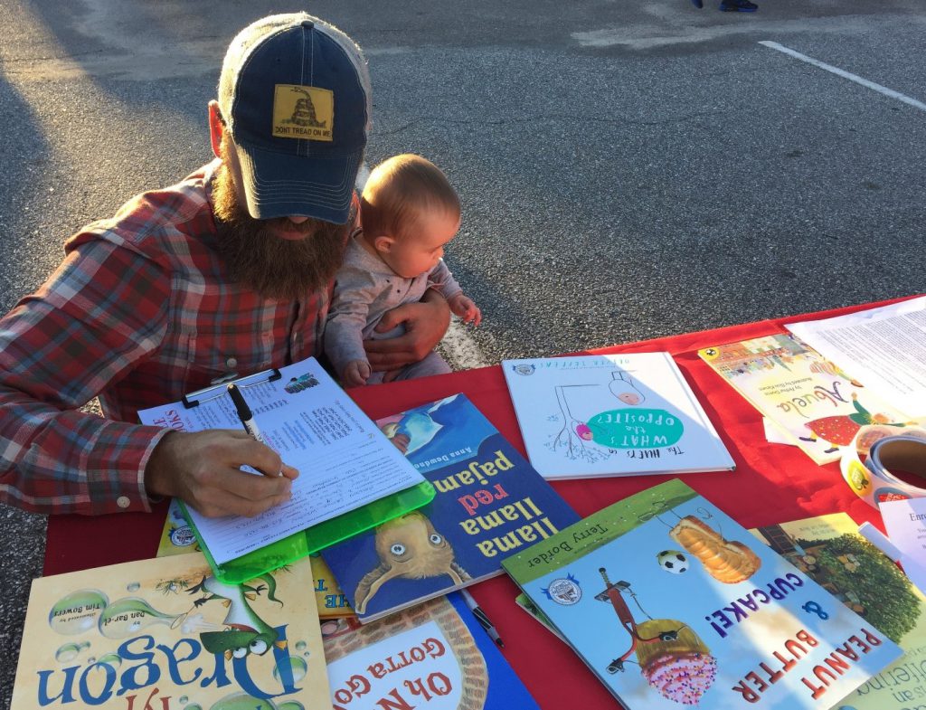 Parent signs his baby up for the BEGIN WITH BOOKS program