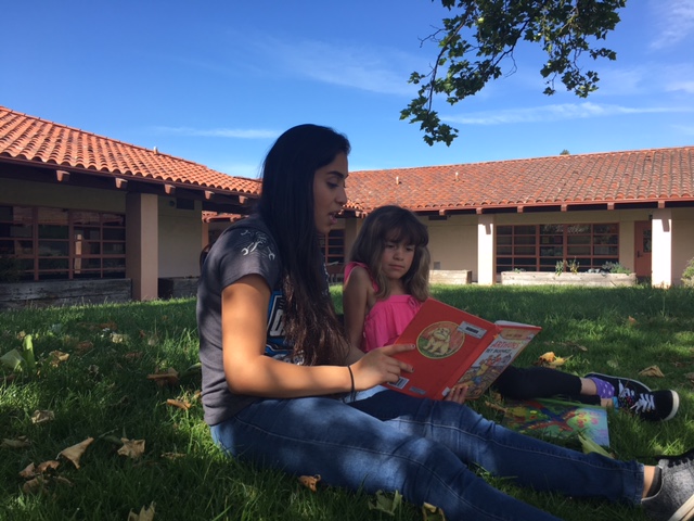 YouthSERVE volunteers with young charge as part of Reading Buddies program