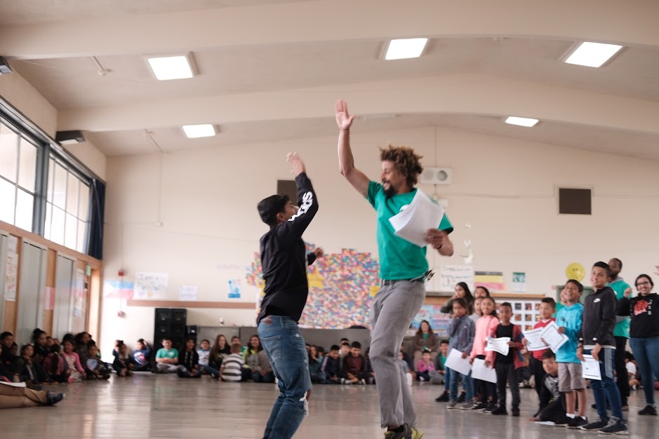 CPY Program Director Ben Bruce high fives a young charge