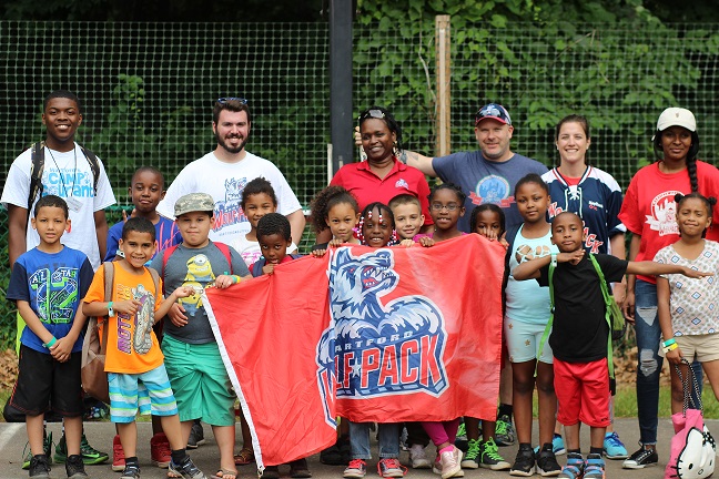 Camp Courant group photo with banner