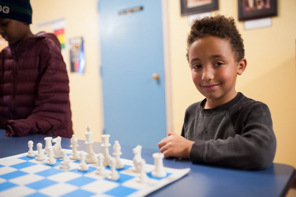 Smiling young chess player
