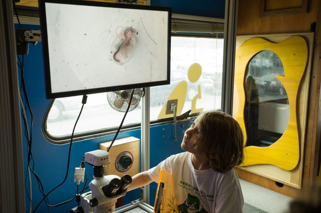 Young girl looks at screen aboard BioBus