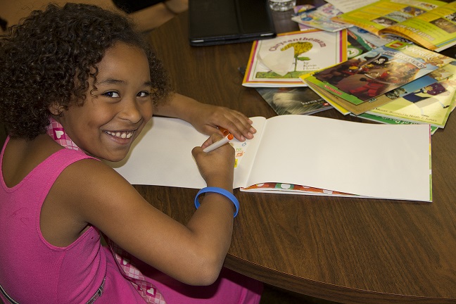Smiling Girl engaged in SMART reading activity
