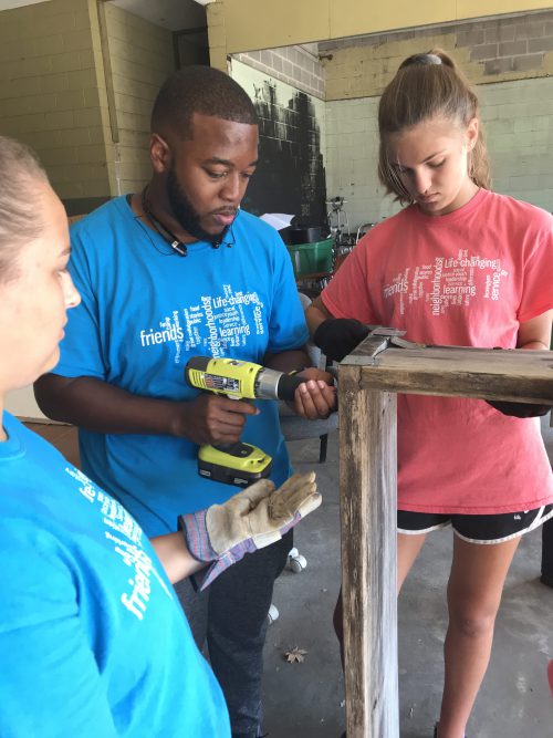 YouthServe campers working on construction project in downtown Ensley (blighted area of Birmingham) for Food Truck events with goal to foster business opportunities.