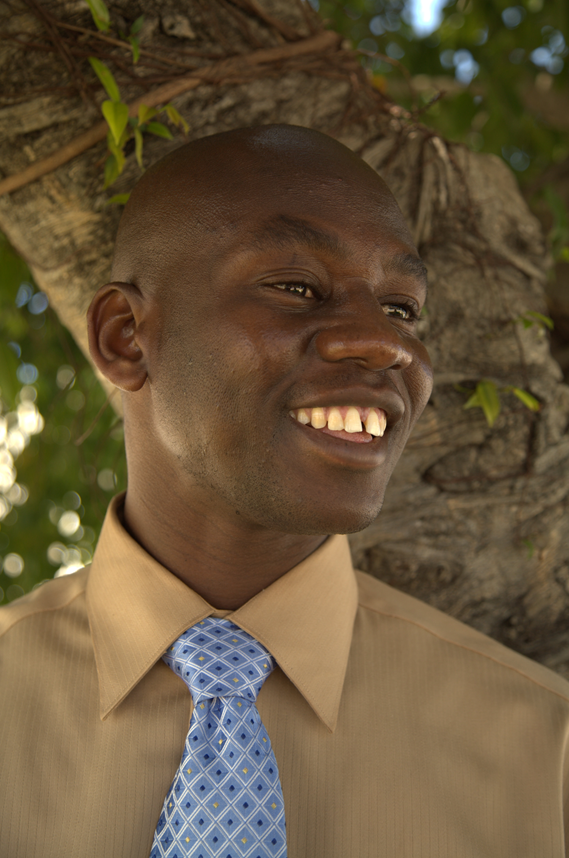 Smiling young black man in button down shirt and tie