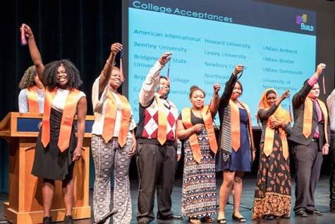 BUILD students hold up their tassels