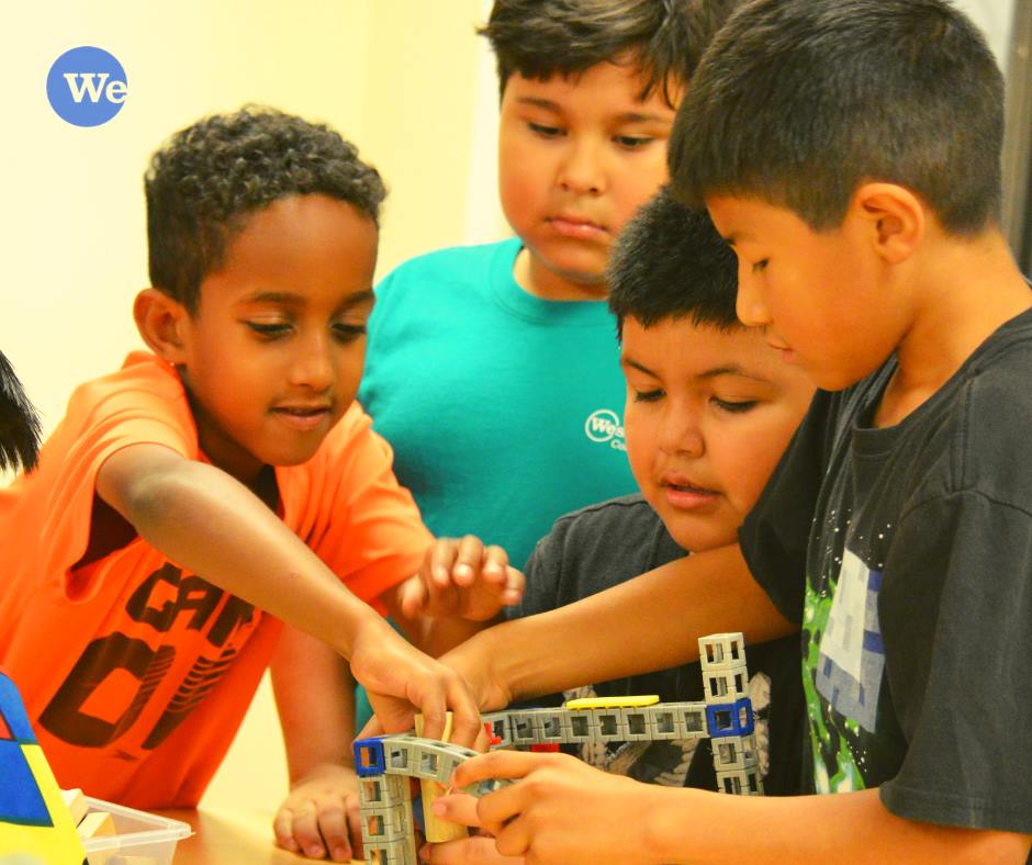 Wesley Rankin after school program participants play with lego