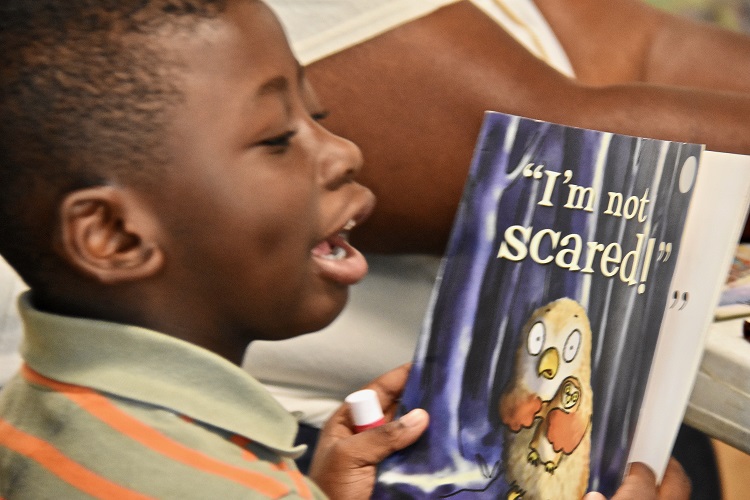 Freedom Readers child reads from a book