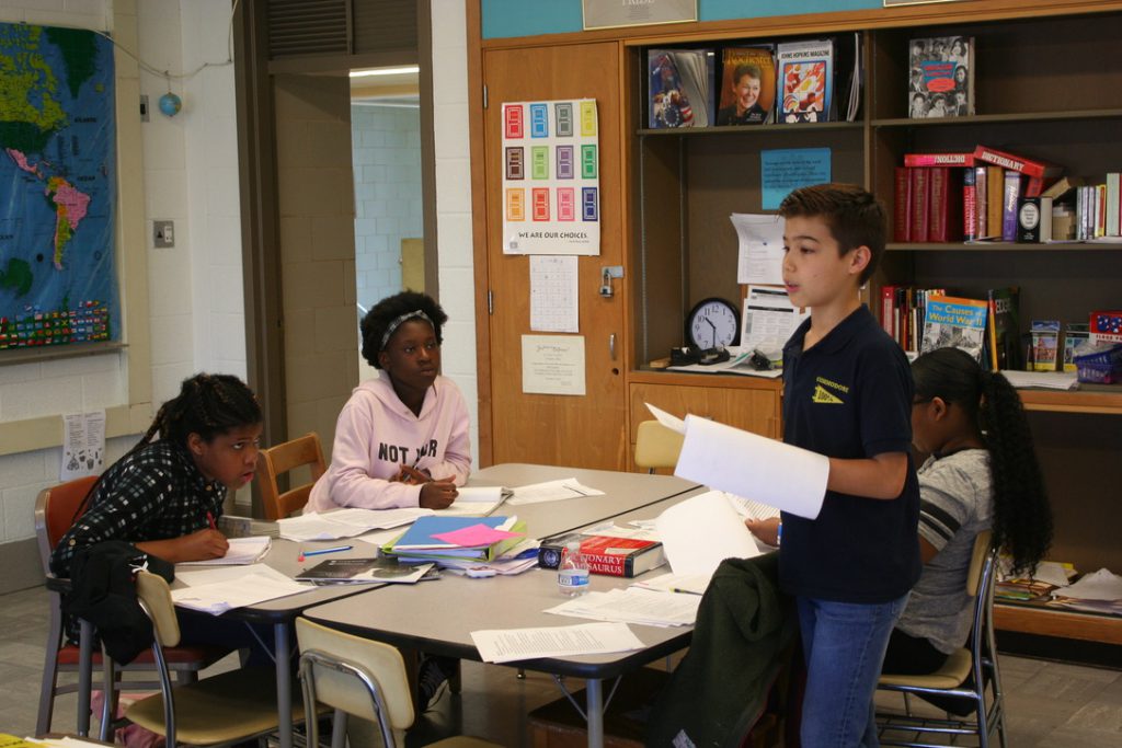 Baltimore Urban Debate League participant reads his debate points 