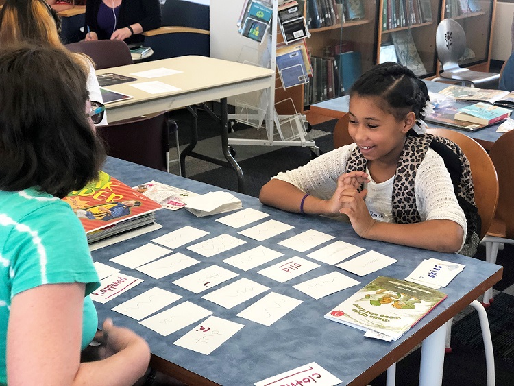 CLC participant plays flash card reading game with volunteer