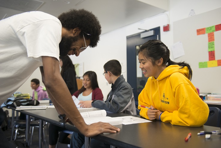 Aim High teacher works with small group of students