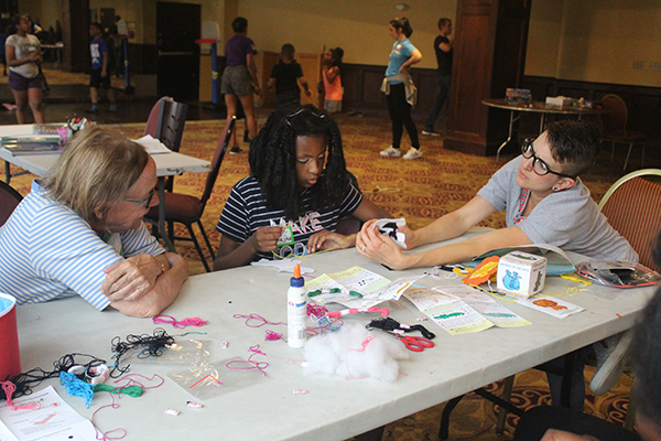 Preteens enjoying an activity at a Homeless Children's Playtime Project entertainment space.