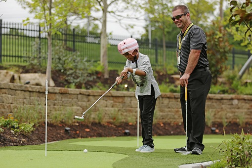 Young man plays golf at Ranken Jordan Pediatric Bridge Hospital