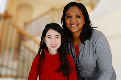 smiling volunteer guardian ad litem with young girl