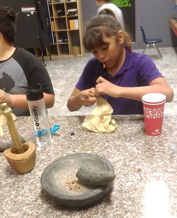 EOBA participants work with mortar and pestle