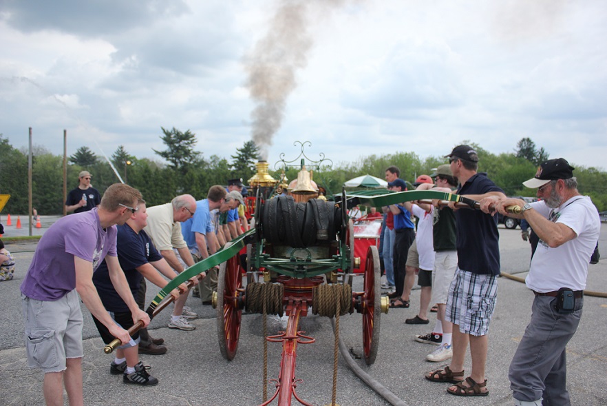 Visitors priming a pump