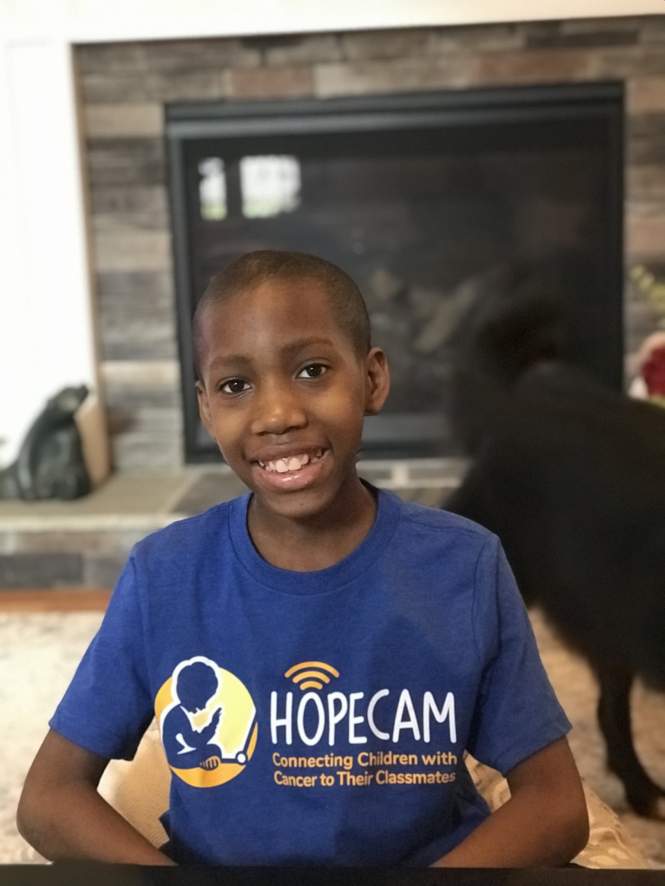 Smiling boy in Hopecam shirt