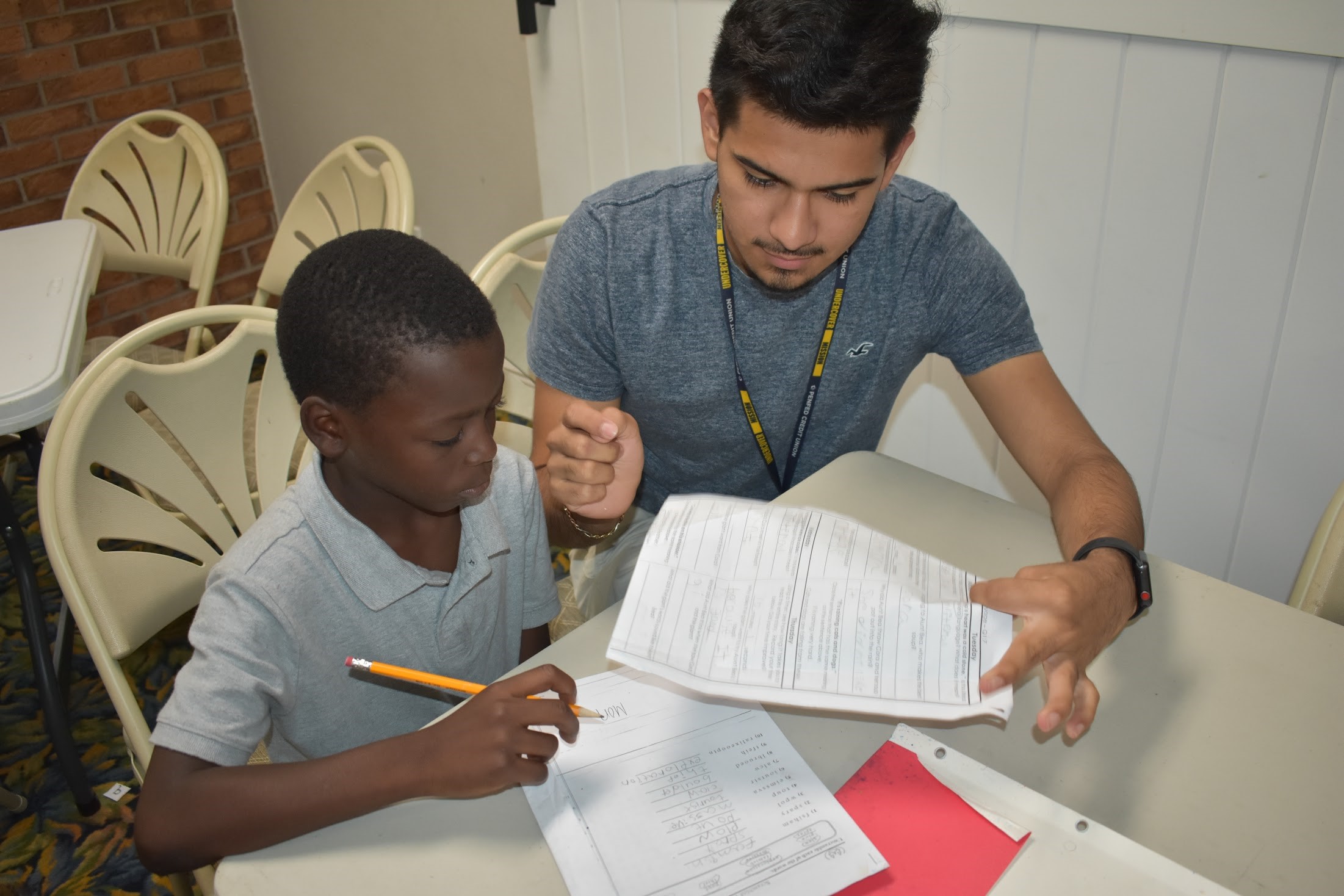 A First Serve Pal mentor works with mentee on homework