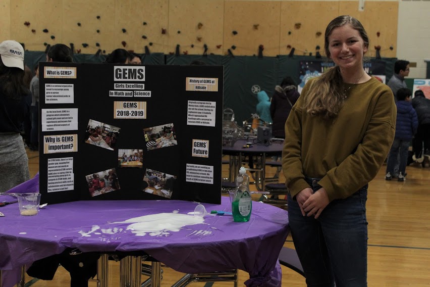 Science exhibit on gems with smiling teenage creator