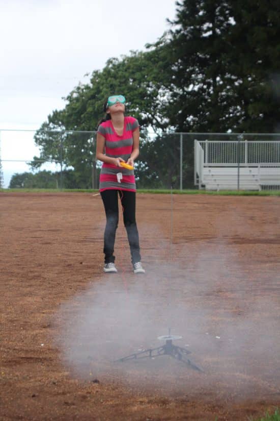 Girl shoots homemade rocket Science Camps of America