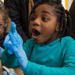 Child expressing excitement over science at BioBase Harlem, BioBus