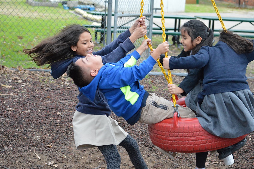 Wesley Rankin Community Center children swing on a playground