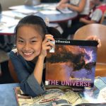 Smiling Asian girl with book from CLC