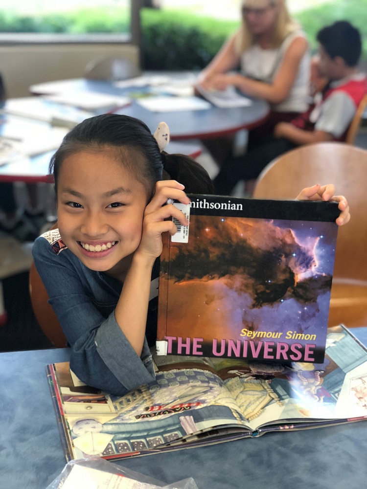 Smiling Asian girl with book from CLC