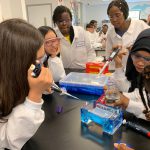 Enroot students conducting experiments at the Biogen Community Lab