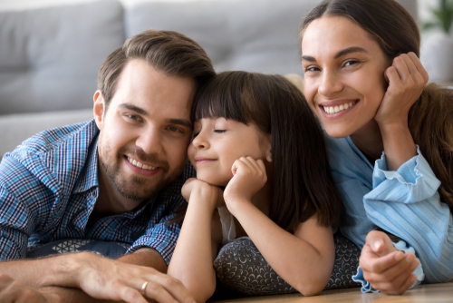 smiling parents and daughter