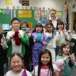 SAGE participants learn how to knit from a senior volunteer