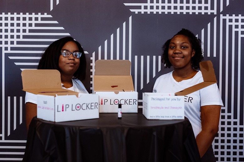 two proud Gray Matter participants display their business products