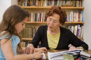 Elderly volunteer reads with child