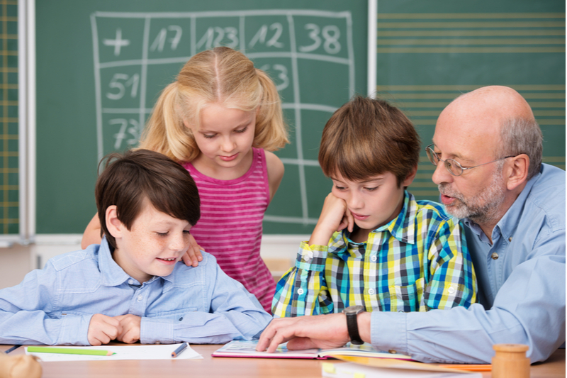 Senior reads to children in the classroom