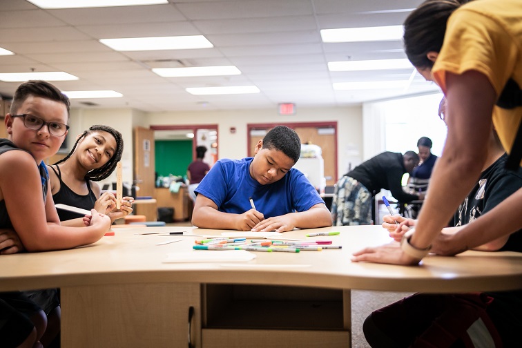 UpSpring participants do homework with the assistance of an UpSpring tutor