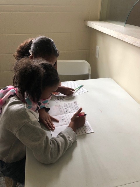 Urban Scholars Academy mentor and mentee do worksheet together