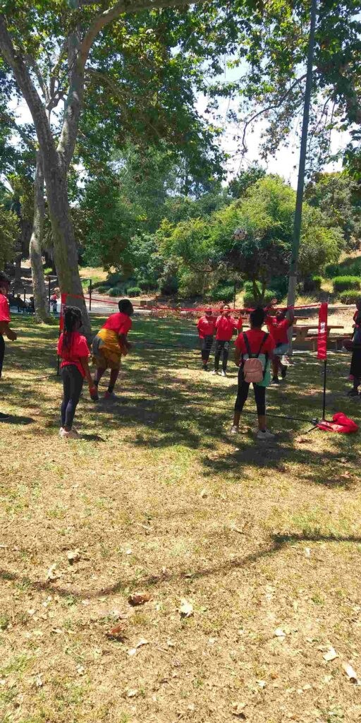 Urban Scholars Academy students play limbo in the park