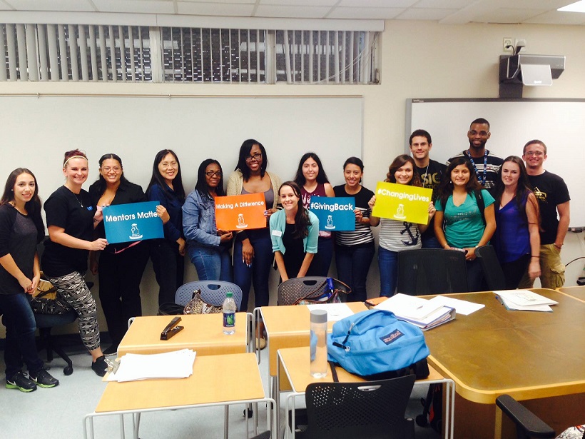 Take Stock in Broward participants in group photo hold up signs describing their educational and career goals.