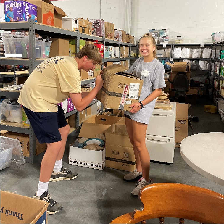 Pebble Tossers participants unloading service supplies