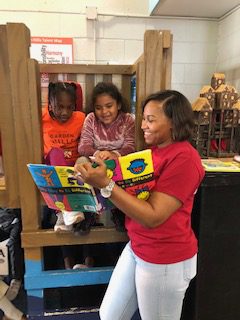 Kids on an indoor jungle gym, have story read to them.