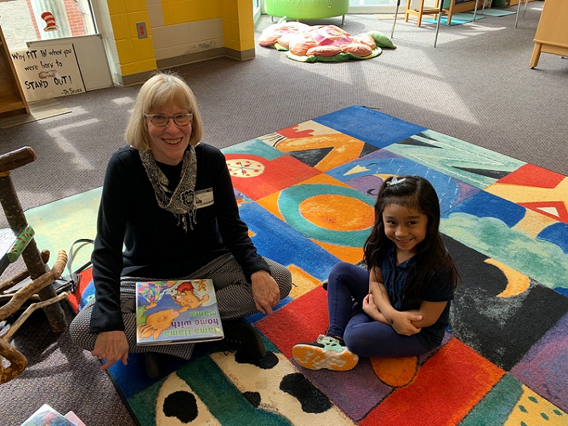 Older woman reads to little girl