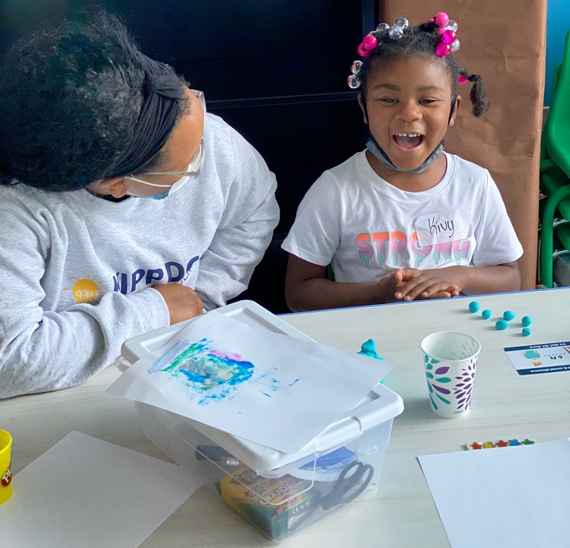 Smiling girl with hortons kids volunteer