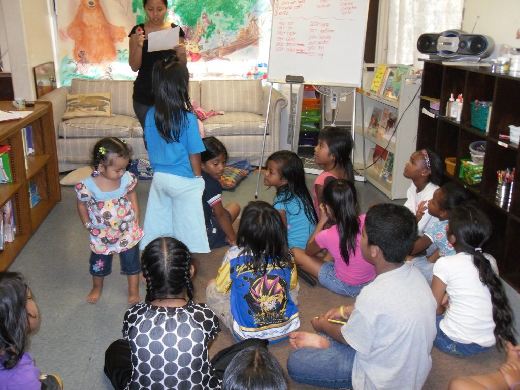 Toddlers wanders through room during storytime at Hawaii Literacy