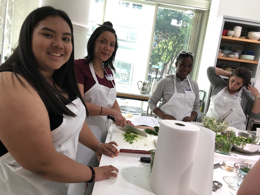 Big Sisters of Boston participants have a cooking lesson