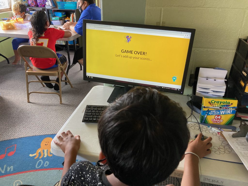 Boy plays games on computer in Hawaii Literacy Technology Room