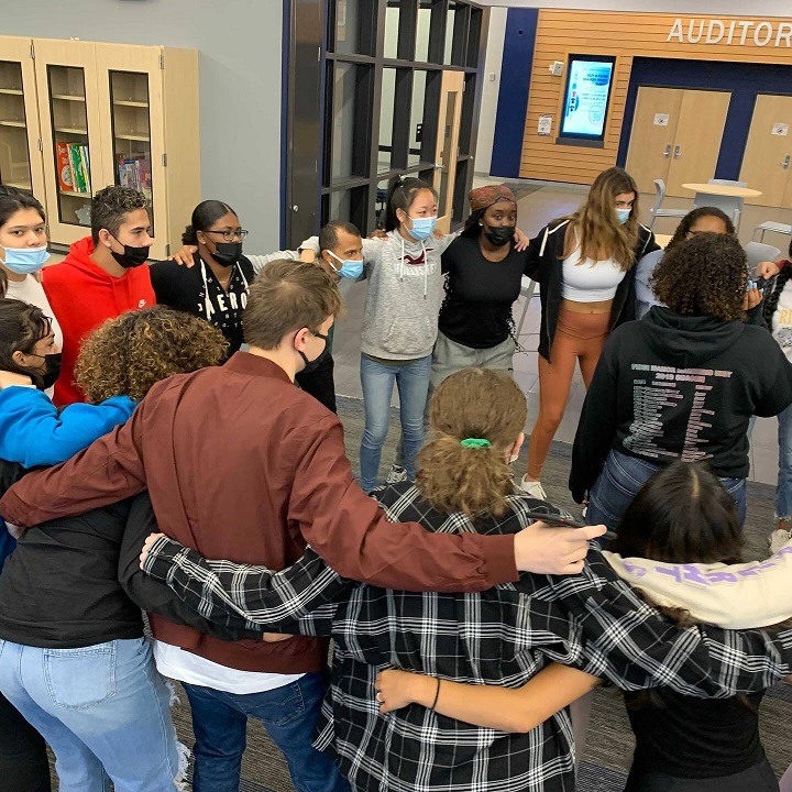 Attollo students huddle in circle