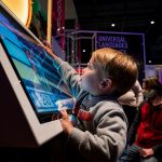 Child interacts with Spark exhibit at The Bakken Museum