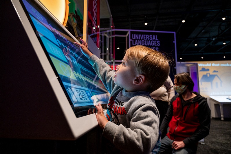 Child interacts with Spark exhibit at The Bakken Museum